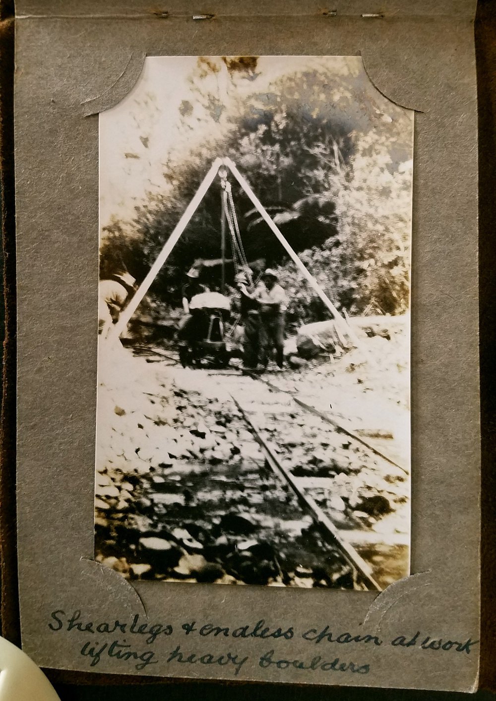 Shearlegs and endless chain at work lifting heavy boulders