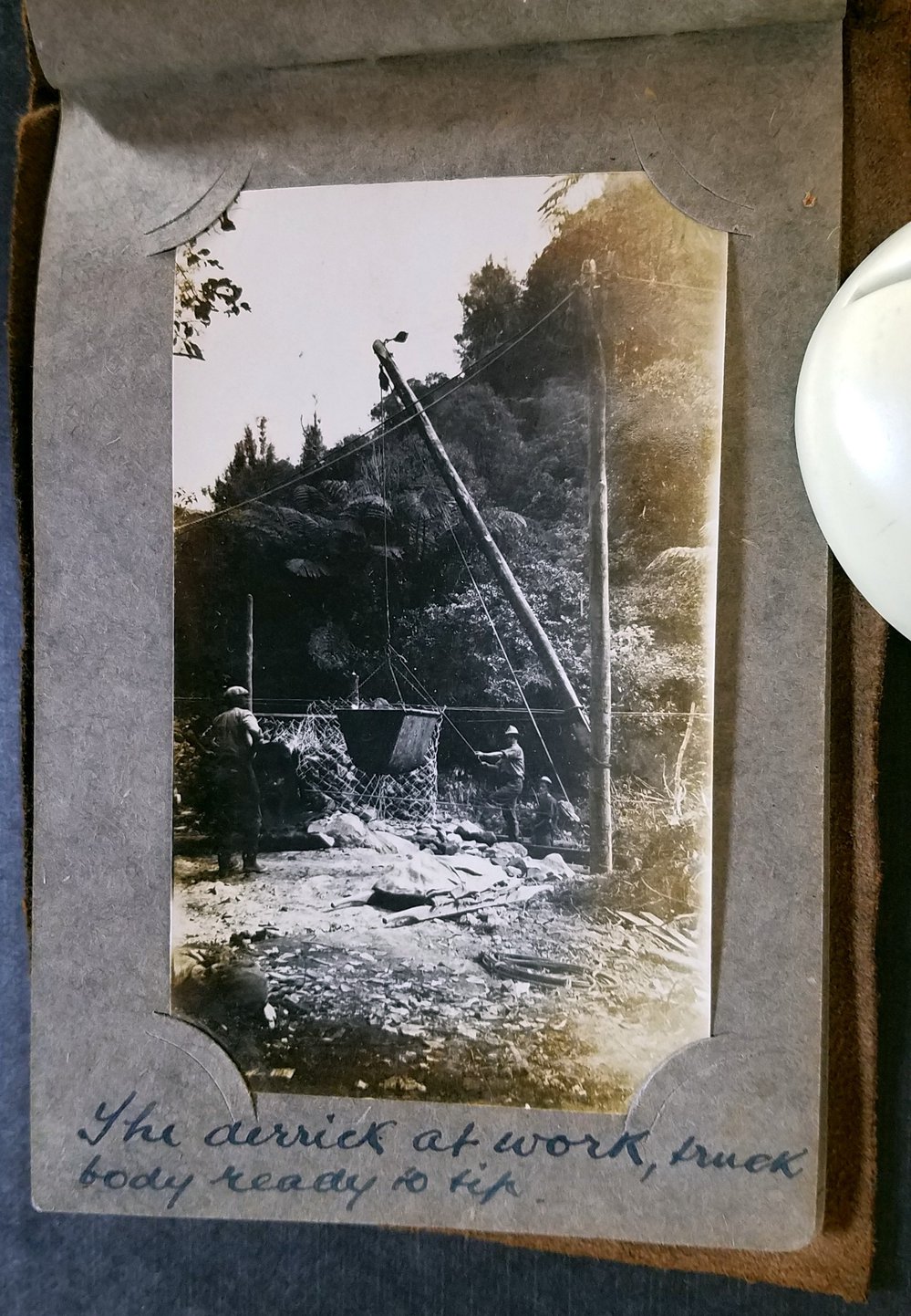 Derrick at work with truck body ready to tip.