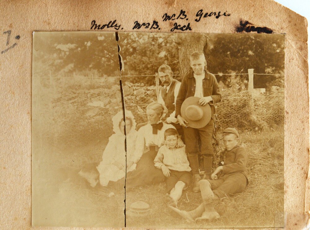 Buckworth family in front of a wire fence