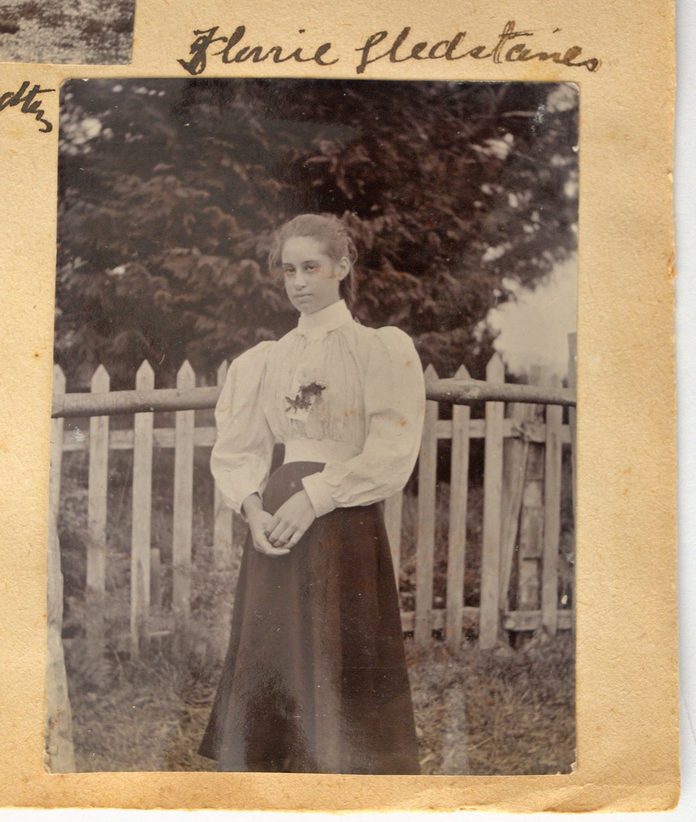 Mary Glestanes in front of a picket fence