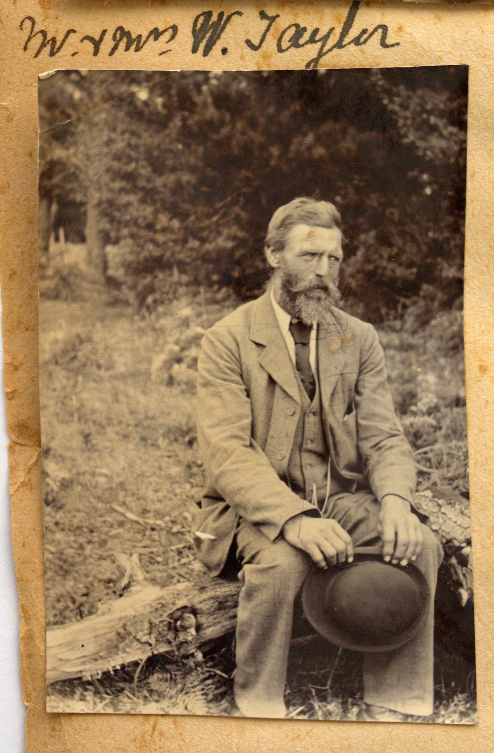 William Taylor sitting on a fallen log.