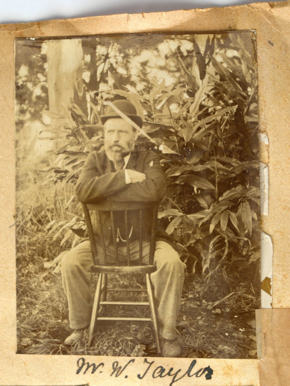 William Taylor sitting on a chair outside.