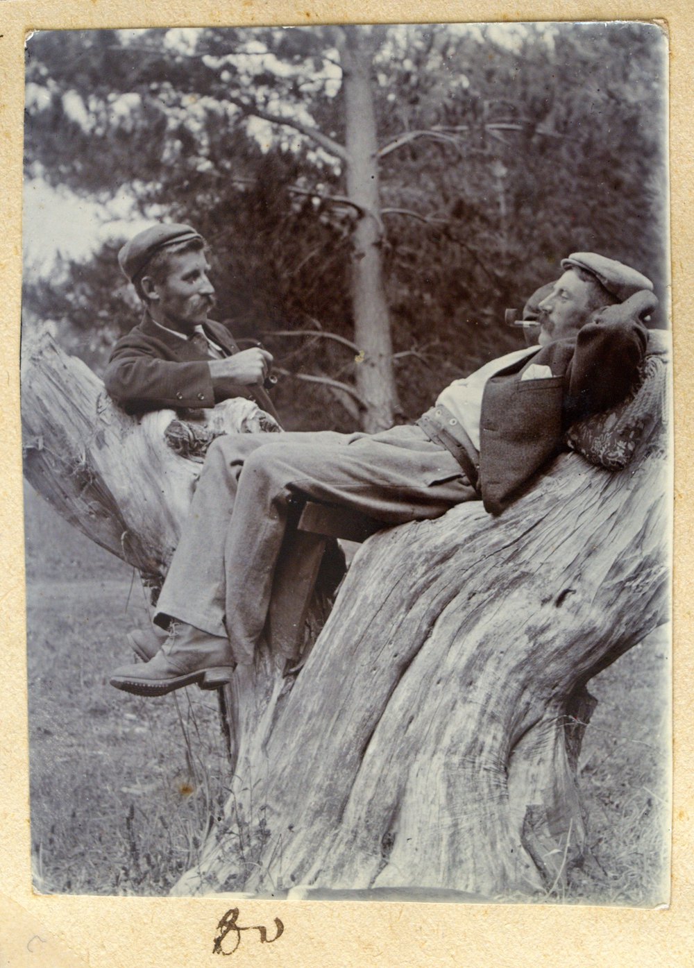 William and Harry Stewart smoking on a tree stump.
