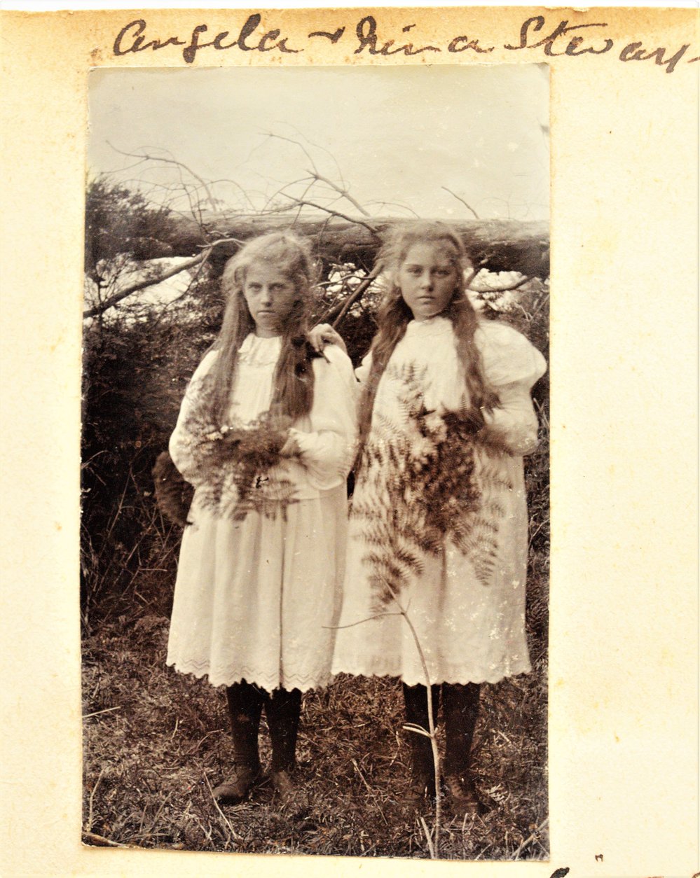 Nina and Angela Stewart holding fern and flower bouquets.
