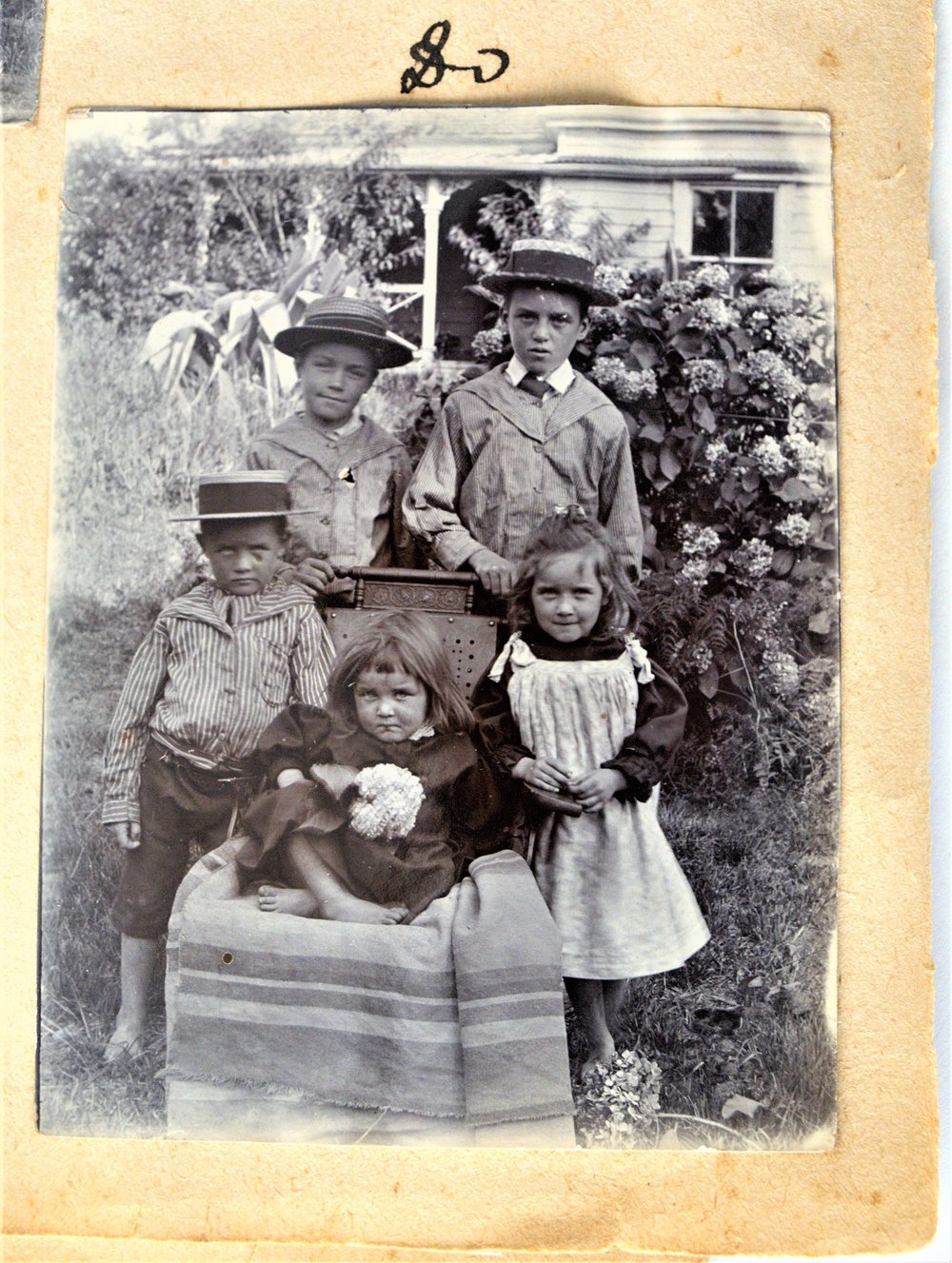 Hugh and Susan Stewart's children wearing straw boaters.