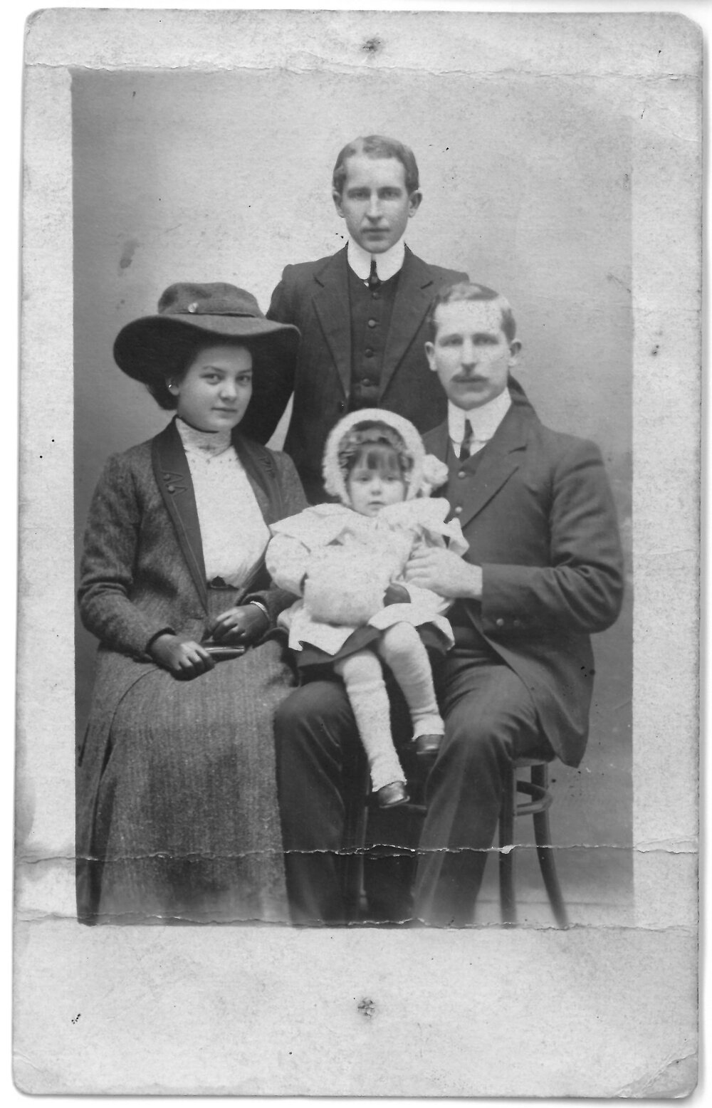 Little Rita Mountier with her parents and uncle (?)