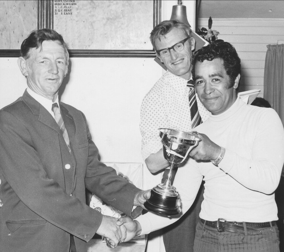 Te Puke Golf Club President Peter Cram presenting a cup to Tui Flavell