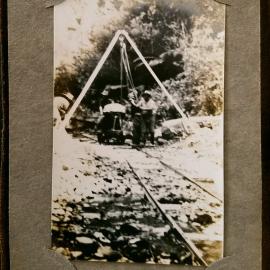 Shearlegs and endless chain at work lifting heavy boulders
