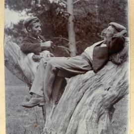 William and Harry Stewart smoking on a tree stump.