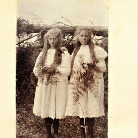 Nina and Angela Stewart holding fern and flower bouquets.