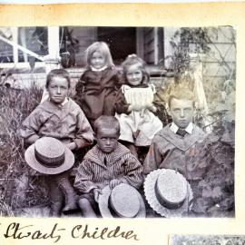 Hugh and Susan Stewart's children sitting on the porch steps.