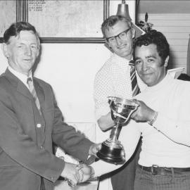 Te Puke Golf Club President Peter Cram presenting a cup to Tui Flavell