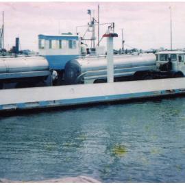 A milk tanker being transported to Matakana Island by barge from Ōmokoroa